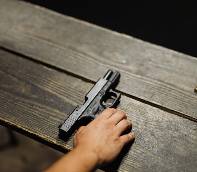 hand of a person holding black semi automatic pistol